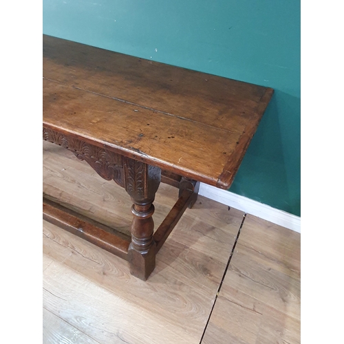 601 - A 17th Century oak Refectory Table with cleated three plank top above leafage arcade carved frieze r... 