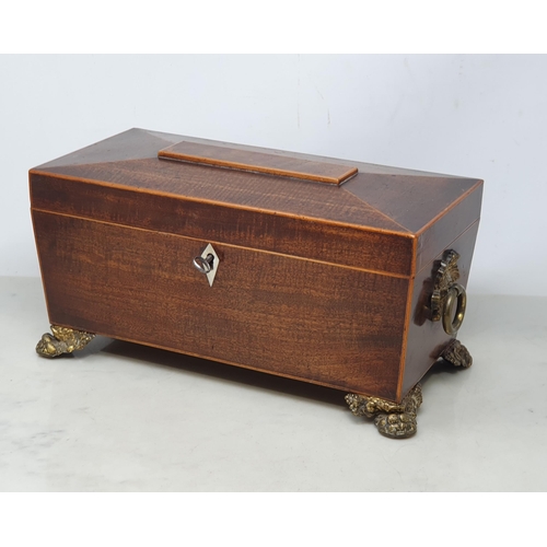 620 - A Regency mahogany Tea Caddy of sarcophagus shape with satinwood stringing having two interior lidde... 