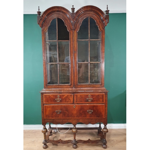 623 - A Queen Anne walnut Cabinet on stand, the double domed top fitted pair of glazed doors with later gl... 