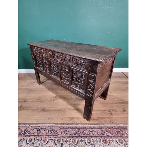 632 - A Lancashire oak Coffer with carved floral frieze, above stylised floral carved panels, bearing the ... 