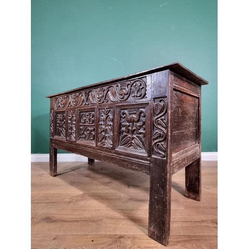 632 - A Lancashire oak Coffer with carved floral frieze, above stylised floral carved panels, bearing the ... 