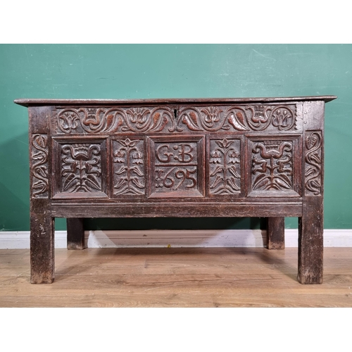 632 - A Lancashire oak Coffer with carved floral frieze, above stylised floral carved panels, bearing the ... 