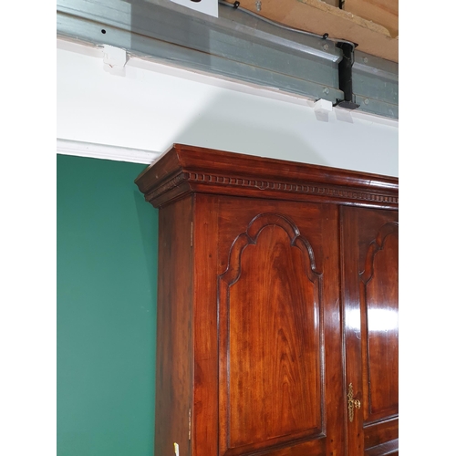 653 - A fruitwood Cupboard with moulded dentil frieze cornice above pair of arched panelled doors enclosin... 