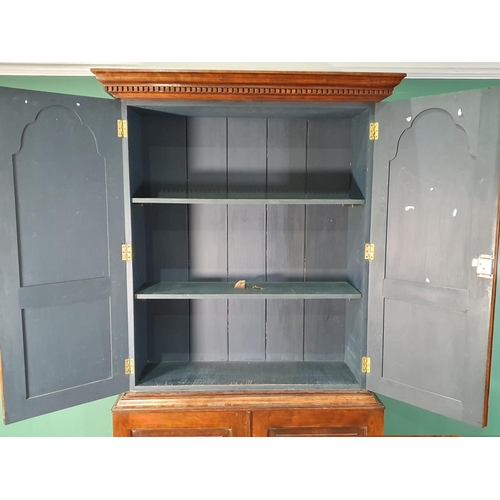 653 - A fruitwood Cupboard with moulded dentil frieze cornice above pair of arched panelled doors enclosin... 