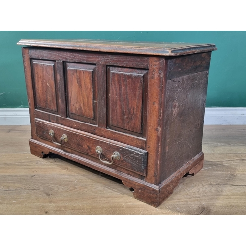 657 - An 18th Century oak and elm Coffer Bach, the moulded top above three fielded panels, with single fit... 