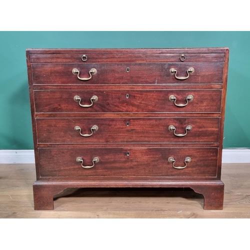 658 - A Georgian mahogany Chest of four long drawers and fitted with a brushing slide on bracket supports,... 