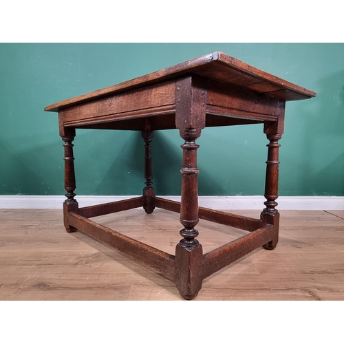 661 - A Mid 17th Century oak low Centre Table, with three plank top raised on turned and tapered supports ... 