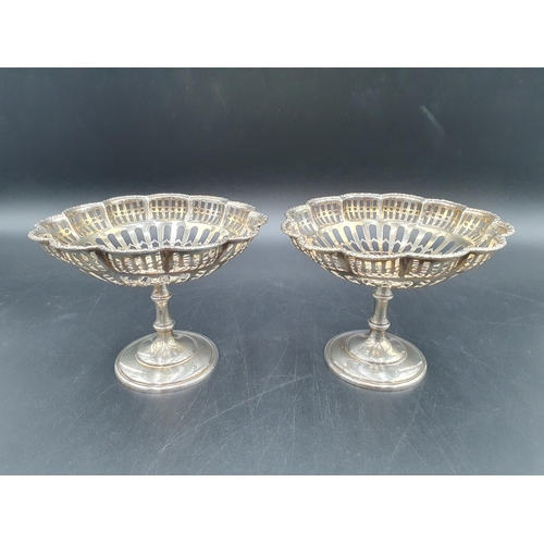 68 - A pair of George V silver Bon bon Dishes of lobed circular form with pierced decoration, on pedestal... 