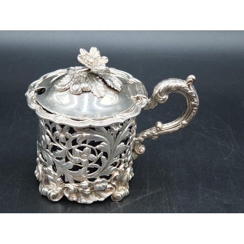 70 - A William IV large silver pierced circular Mustard Pot with floral and scroll embossing, engraved cr... 