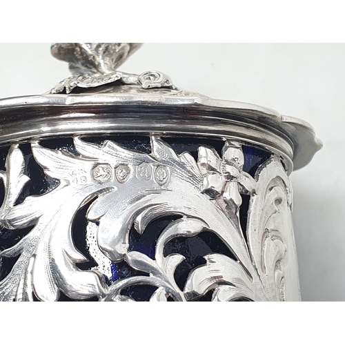 70 - A William IV large silver pierced circular Mustard Pot with floral and scroll embossing, engraved cr... 