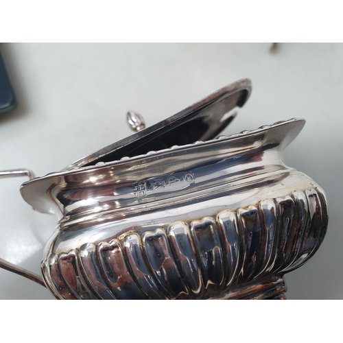 71 - An Edward VII silver Sauce Boat with leafage scroll handle on three hoof feet, Birmingham 1904, and ... 