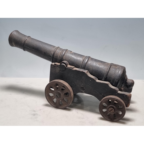 783 - A 20th Century cast iron model Canon, mounted on painted wooden carriage and cast spoked wheels, bar... 