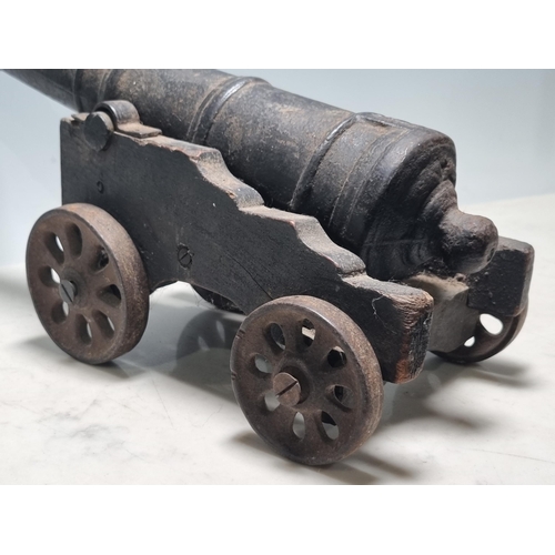 783 - A 20th Century cast iron model Canon, mounted on painted wooden carriage and cast spoked wheels, bar... 