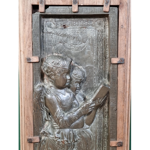 786 - A cast bronze relief Plaque/Panel, depicting standing winged Angels reading a Book, mounted in a mou... 