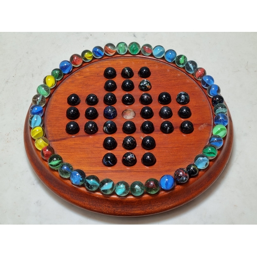 793 - A 19th Century mahogany Jaques of London Solitaire Board and a collection of assorted Marbles.