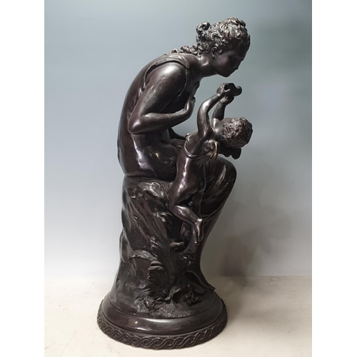 797 - A bronze Figure Group of a seated woman being fed by a winged cherub, 21in H