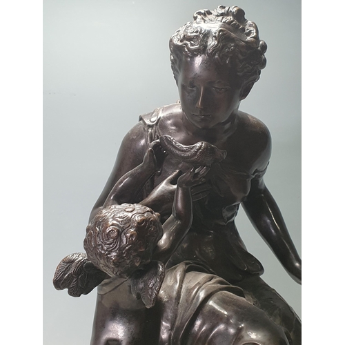 797 - A bronze Figure Group of a seated woman being fed by a winged cherub, 21in H