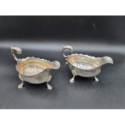 8 - A pair of George III silver Sauce Boats engraved dragon crests, leafage scroll handles on hoof feet,... 