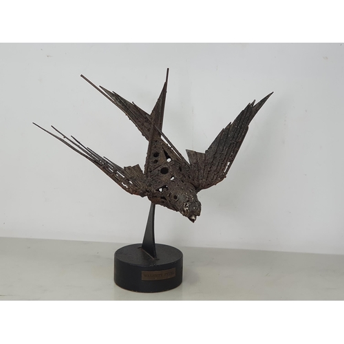 823 - WALENTY PYTEL; metal Sculpture of a Swallow, on circular plinth, wingspan 13in