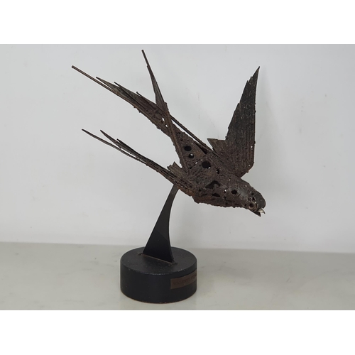 823 - WALENTY PYTEL; metal Sculpture of a Swallow, on circular plinth, wingspan 13in