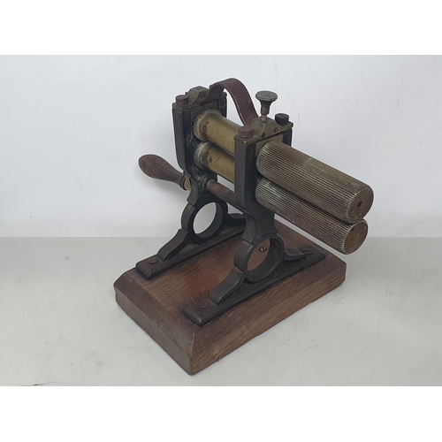 824 - A 19th Century mahogany Wool Winder with brass wheel and handle 9in H and an antique Crimper