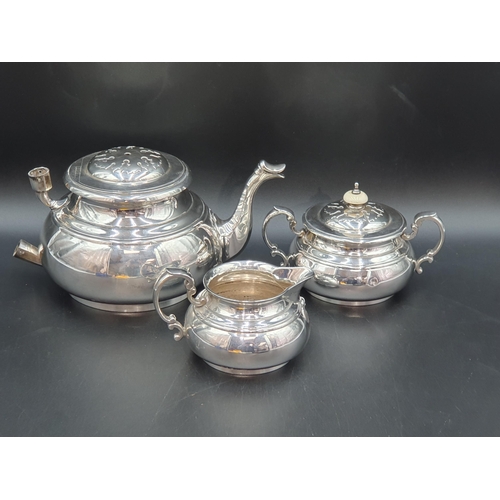 83 - A George VI silver three piece Tea Service of bellied form with strapwork frieze, London 1938, maker... 