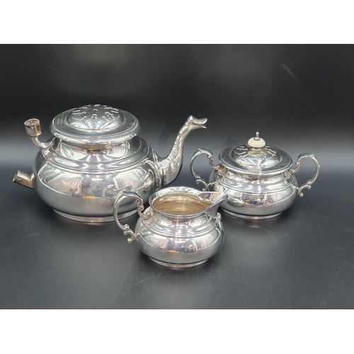 83 - A George VI silver three piece Tea Service of bellied form with strapwork frieze, London 1938, maker... 