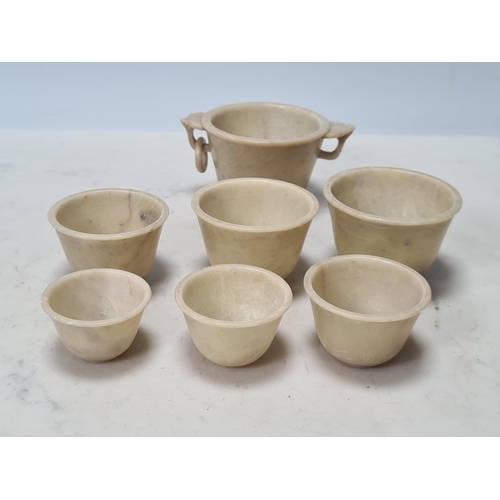 844 - A set of seven soapstone graduated Bowls the largest with pierced leafage design loop handles A/F, a... 