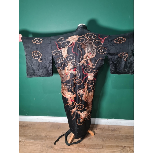 853 - A  Japanese Kimono with gold and red thread dragon design in relief on a black ground