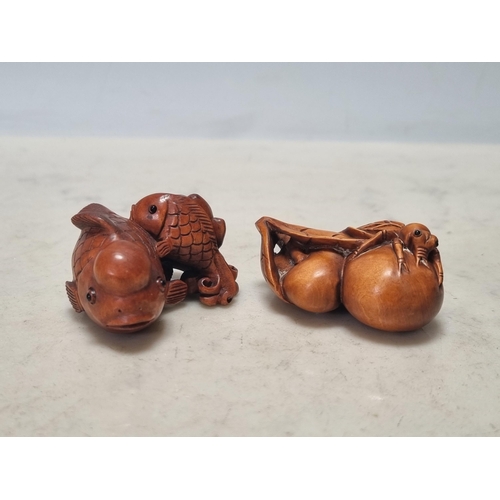 862 - Two carved wood Netsuke in the form of fish and an insect on fruit