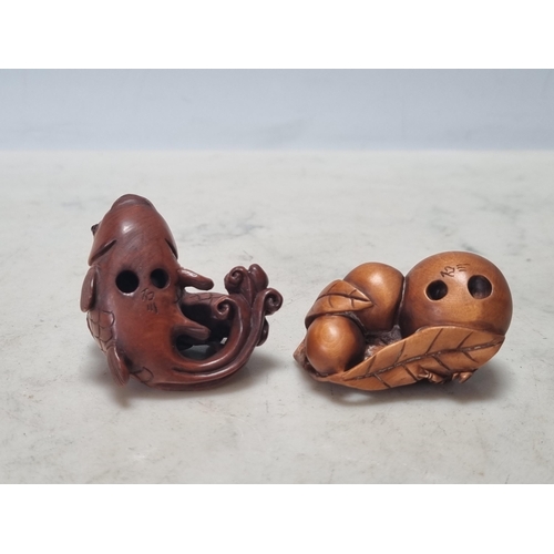 862 - Two carved wood Netsuke in the form of fish and an insect on fruit