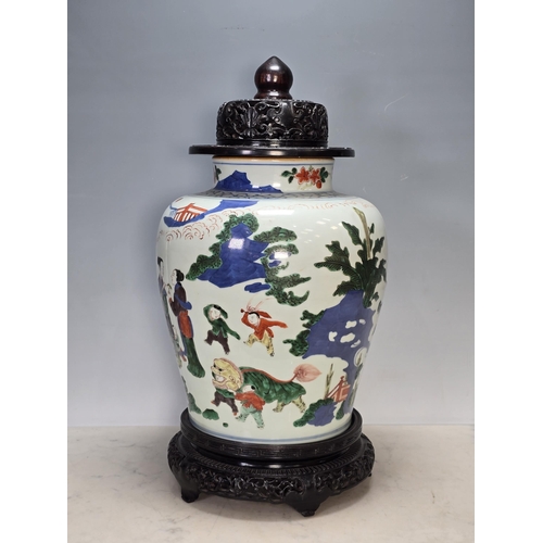 867 - **** AMENDMENT **** A Chinese Wucai baluster Vase, Qing Dynasty, depicting boys at play in a garden ... 