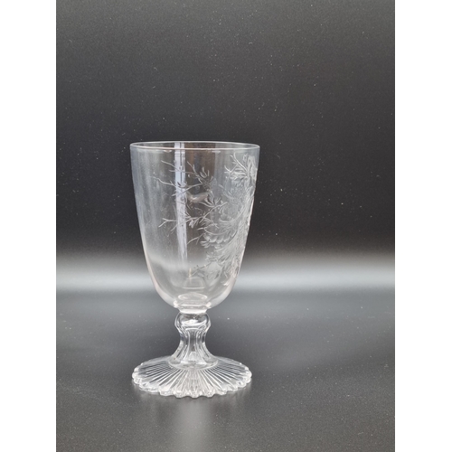 870 - An antique intaglio cut-glass wine with scroll, leafage and bird decorated conical bowl, on short st... 