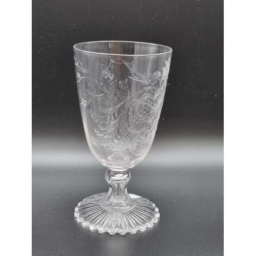 870 - An antique intaglio cut-glass wine with scroll, leafage and bird decorated conical bowl, on short st... 