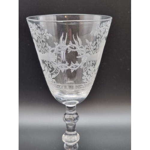 871 - A Dutch engraved baluster Wine glass, the round funnel bowl engraved two hands holding a thorny wrea... 