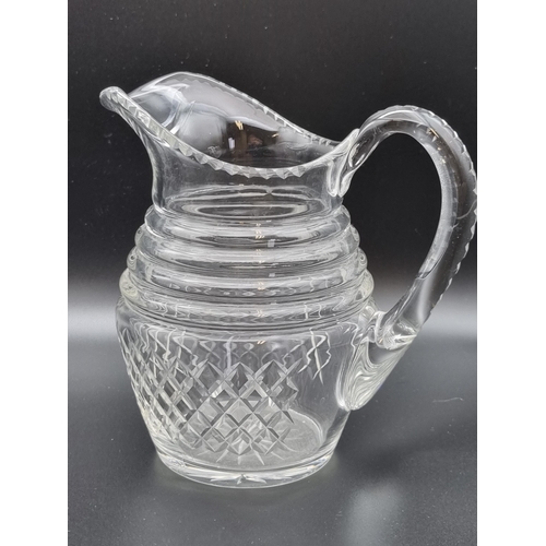 880 - An antique glass Jug engraved monogram, fruiting vine, leafage and swag designs, ribbed base, 6 1/4i... 