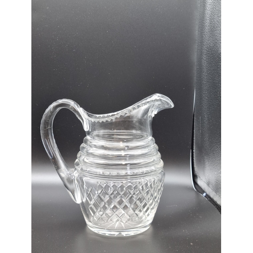 880 - An antique glass Jug engraved monogram, fruiting vine, leafage and swag designs, ribbed base, 6 1/4i... 