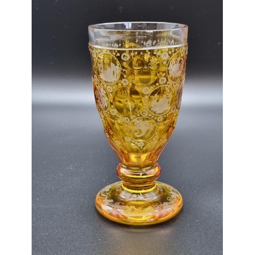 883 - An amber glass with engraved panels, birds, flowers and buildings, and a small green glass Jug with ... 