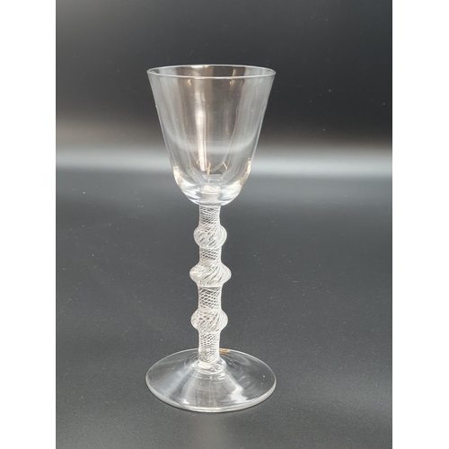 891 - A balustroid wine glass with air twist stem, triple knop with plain bucket bowl 6 3/4in H