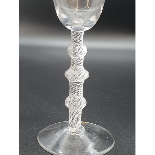 891 - A balustroid wine glass with air twist stem, triple knop with plain bucket bowl 6 3/4in H