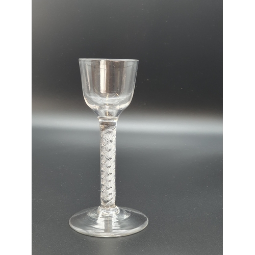 892 - An antique wine glass with bucket bowl, air twist stem on domed base