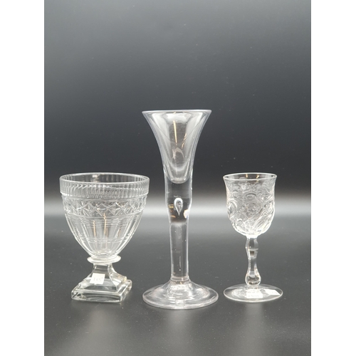 898 - A wine with trumpet bowl, tear drop stem, a small wine with fluted and floral engraved on baluster f... 