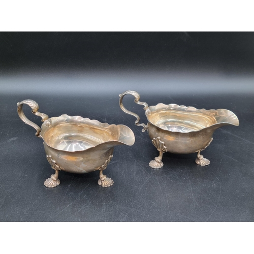 9 - A pair of George II silver Sauce Boats with scroll handles on ornate supports and shaped feet, Londo... 