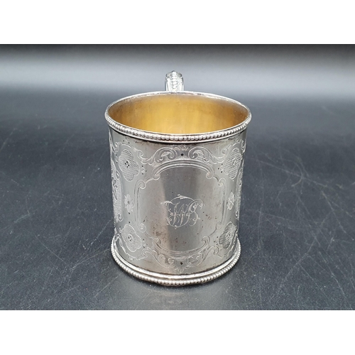 90 - A Victorian silver Christening Mug with floral engraving and initials, beaded rim, Sheffield 1862, m... 