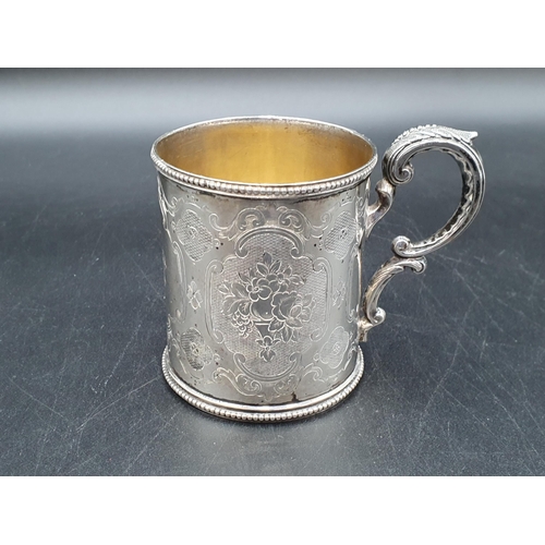 90 - A Victorian silver Christening Mug with floral engraving and initials, beaded rim, Sheffield 1862, m... 