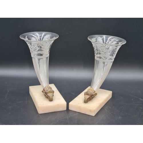 900 - A pair of etched glass Cornucopia on gilt metal ram's head and white marble bases, chipped