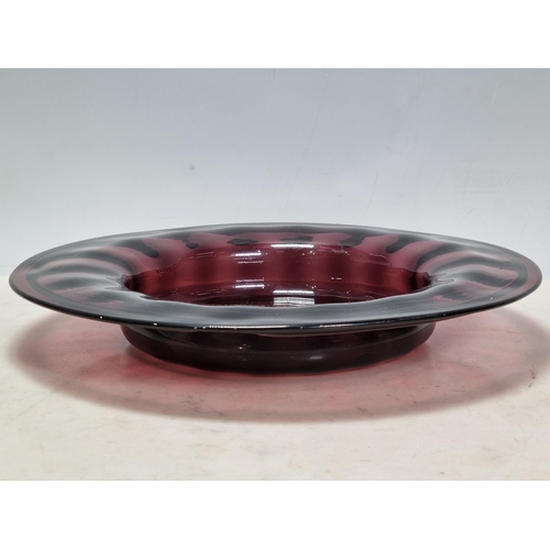 903 - Studio Glass to include, a black glass Candle Holder, an amethyst coloured glass shallow Bowl, 11.5