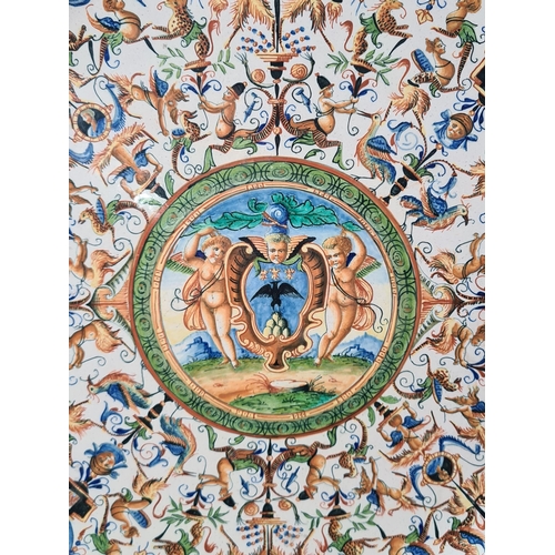 904 - A Continental Miolica Charger decorated with borders of mythical beasts, the centre with circular pa... 