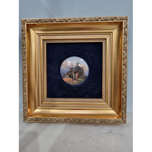 910 - A framed painted circular porcelain Panel of two Scottish Hunters in a highland landscape, 2 1/2in D