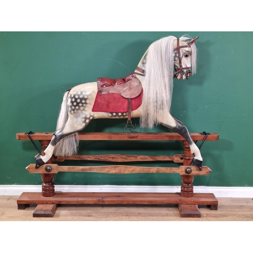 921 - A large carved and painted dapple grey Rocking Horse, with glass eyes, open mouth and flared nostril... 